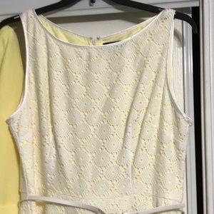 White crochet dress with a light yellow lining,sleeveless with zipper and belt